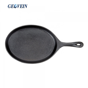 cast iron sizzling steak plate on wooden base